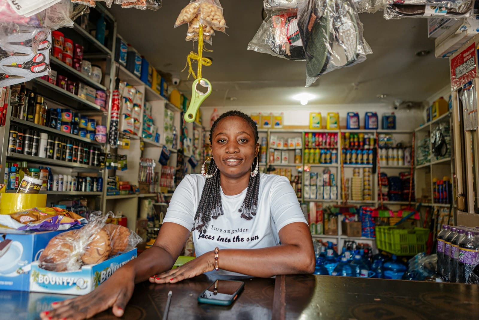 A shop owner at the counter of her small retail store